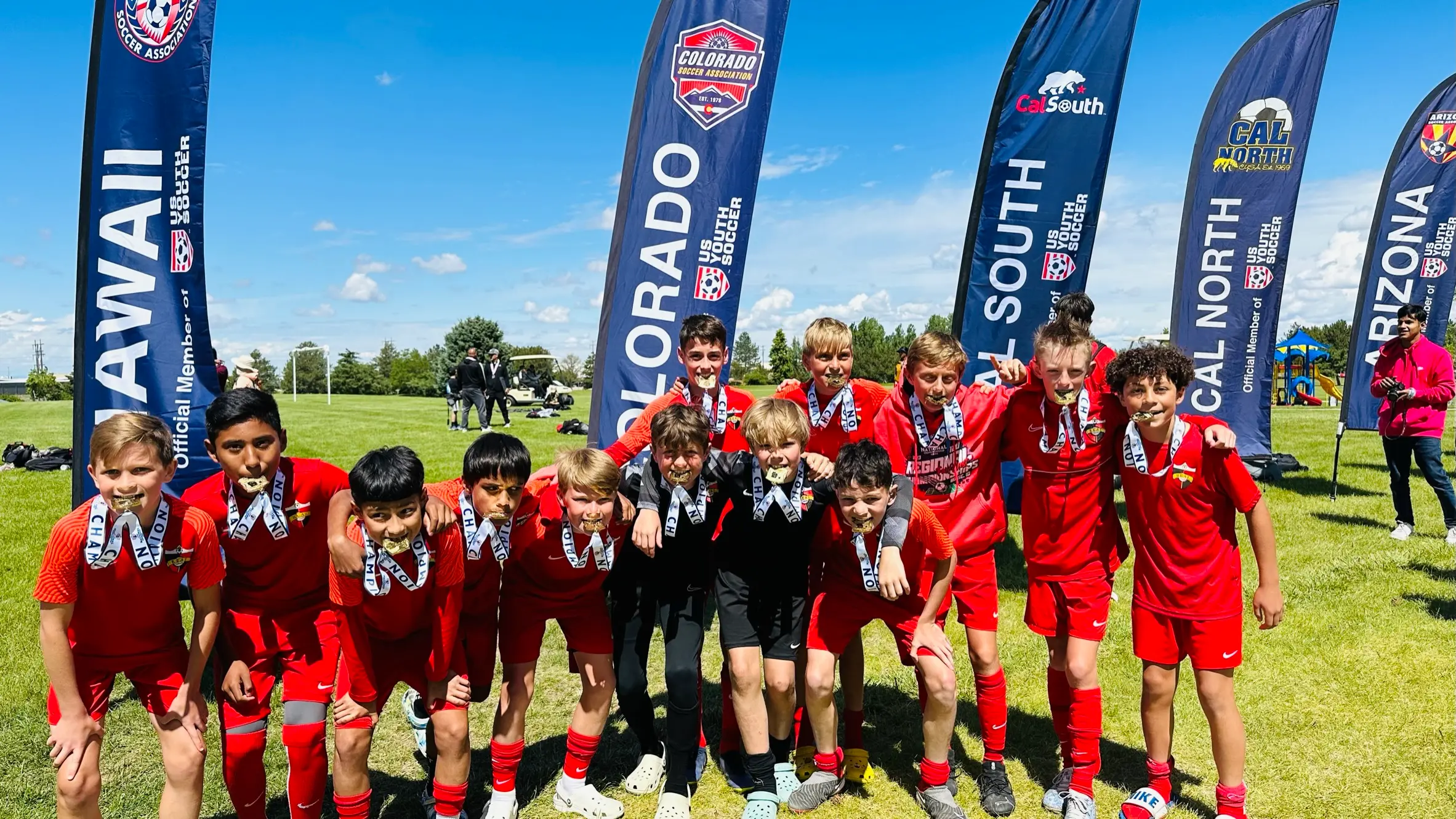 Colorado ODP team in black Nike kits with numbered bibs posing in front of US Youth Soccer ODP tent at Mercedes-Benz Stadium